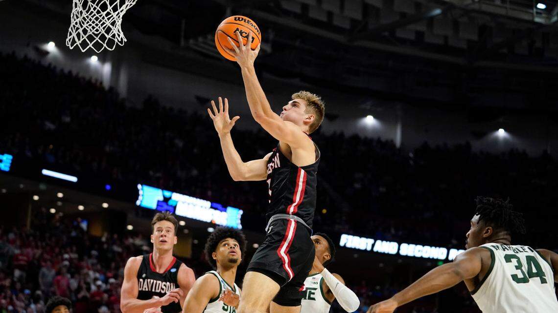 Davidson’s Grant Huffman, center, shoots and scores against Michigan State during the first half of a college basketball game in the first round of the NCAA tournament Friday, March 18, 2022, in Greenville, S.C. (AP Photo/Brynn Anderson)