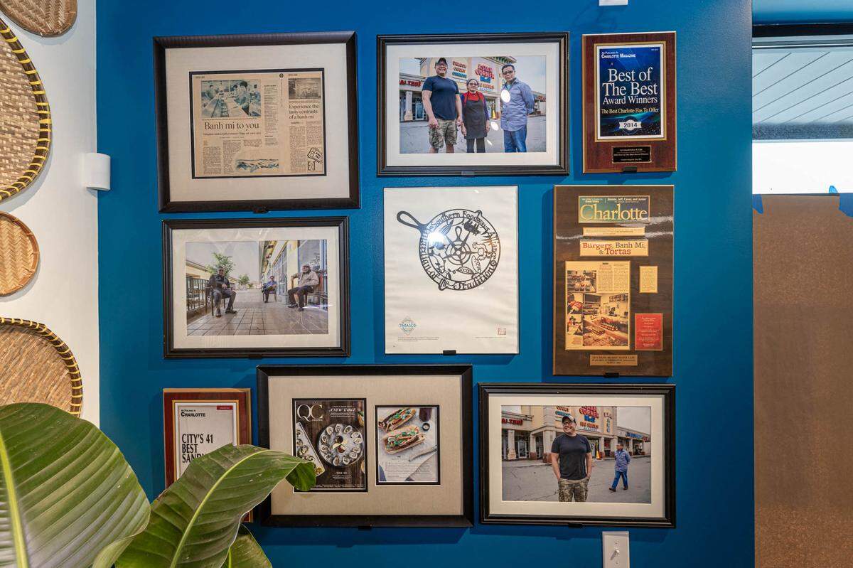 At its new location, Le’s Sandwiches displays photos and stories from the old Asian Corner Mall where it was previously located, including three framed photos from CharlotteFive.
