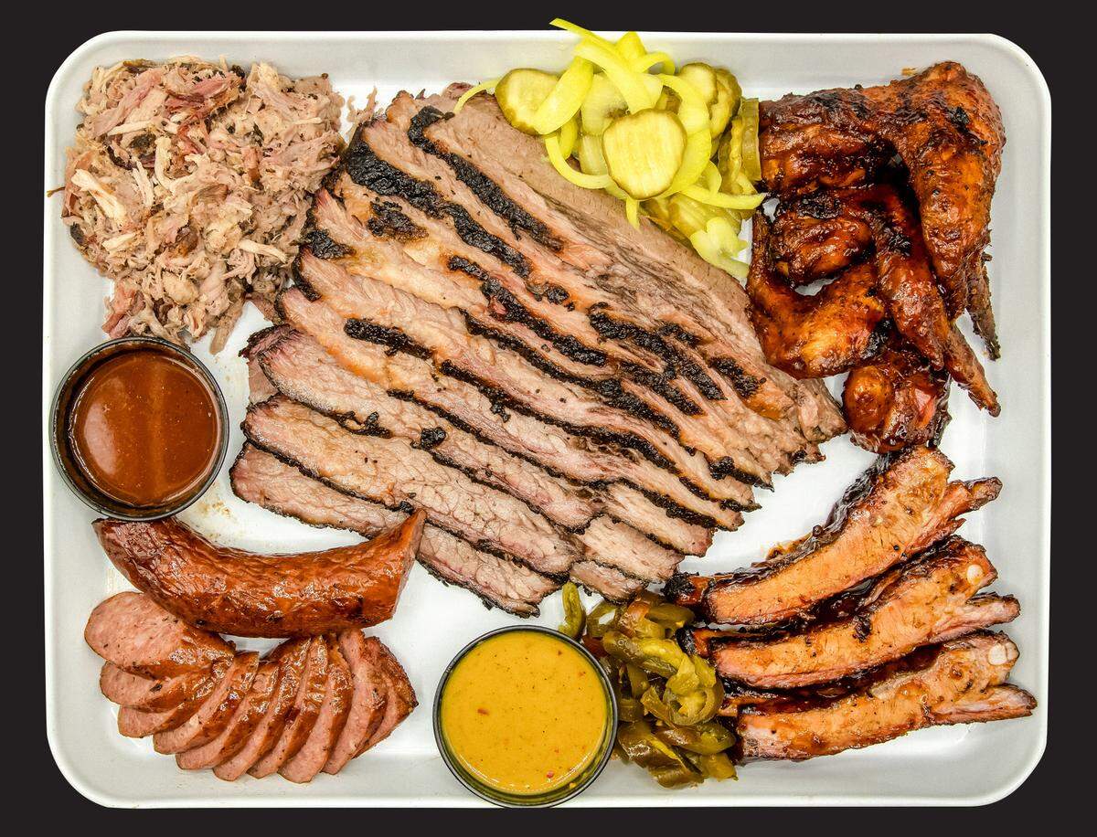 The Smoke Pit’s barbecue offerings include hickory smoked pulled pork, Texas brisket, smoked chicken quarters, smoked sausage and ribs.