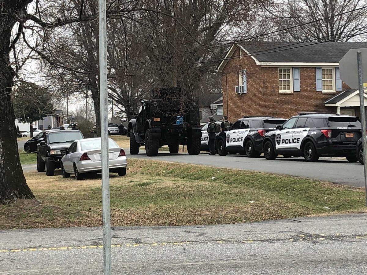 Concord police officers, including a SWAT team, surround a home on Collingswood Drive on Tuesday, Feb. 22, 2022. Police later arrested Lavender Jay Sinclair, who was wanted in connection with a Feb. 13 shooting in Charlotte, NC.