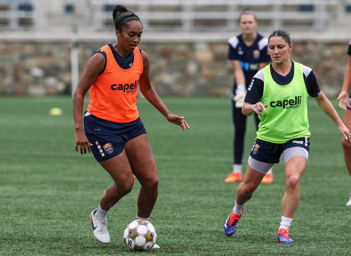 Ascent FC forwards Mia Corbin, left, dribbles the ball by and Rylee Baisden during a practice at American Legion Memorial Stadium in Charlotte, NC on Wednesday, August 13, 2025.