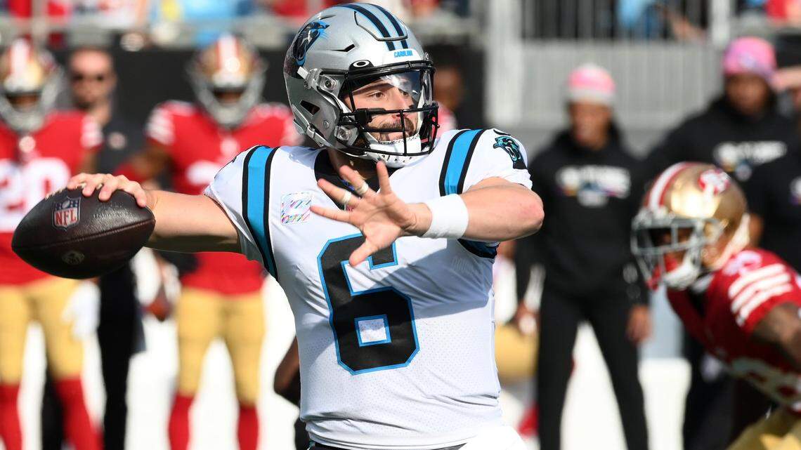 Carolina Panthers quarterback Baker Mayfield drops back to pass against the San Francisco 49ers during first quarter action at Bank of America Stadium on Sunday, October 9, 2022.