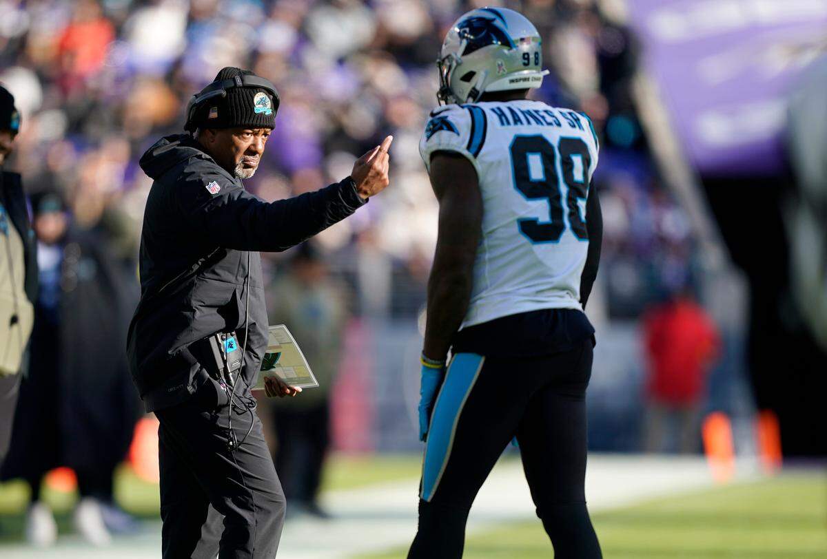 Carolina Panthers head coach Steve Wilks talks with Carolina Panthers defensive end Marquis Haynes Sr. (98) in the first half of an NFL football game against the Baltimore Ravens Sunday, Nov. 20, 2022, in Baltimore. (AP Photo/Patrick Semansky)