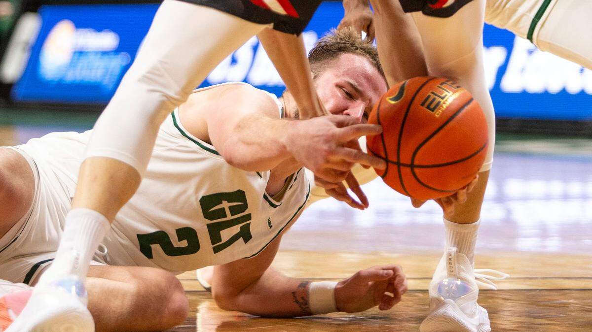 Charlotte’s Austin Butler (2) tries to gain possession of the ball against Davidson during a game at Halton Arena in November. The 49ers are welcoming fans back to Halton Arena after a brief pause due to COVID.