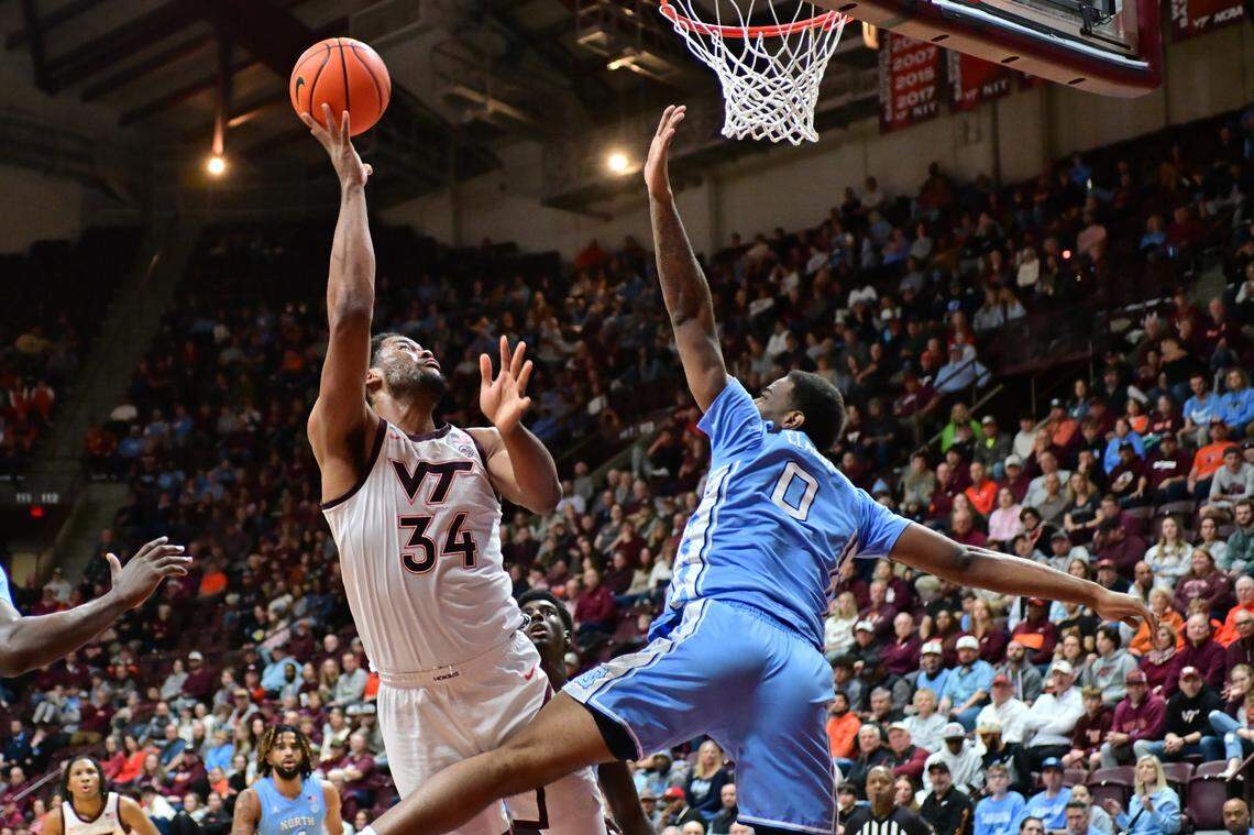 Mar 4, 2025; Blacksburg, Virginia, USA; Virginia Tech Hokies forward Mylyjael Poteat (34) goes up for a shot as North Carolina Tar Heels forward Ty Claude (0) defends during the first half at Cassell Coliseum.