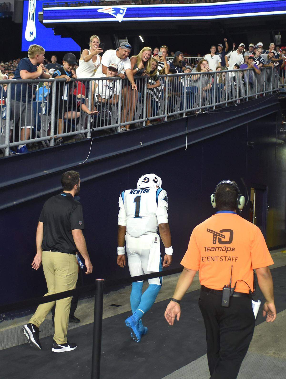 Fans look over the railing at Carolina Panthers quarterback Cam Newton as he heads to the locker room under his own power after injuring his left foot during the first quarter Thursday.