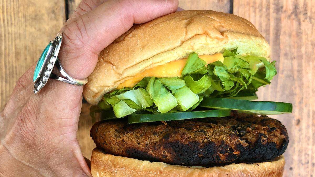 Crepe Cellar’s Black Bean & Carrot Veggie Burger is served with cucumbers, local greens, and sweet potato aioli on a brioche bun.