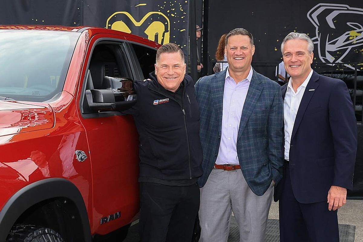 BROOKLYN, MICHIGAN - JUNE 08: (L-R) Tim Kuniskis, CEO Ram Brand - Stellantis, NASCAR Executive Vice President Steve O'Donnell and John Probst, SVP of Innovation and Racing Development pose at the Ram display on the midway for the announcement that the Ram brand will return to NASCAR Craftsman Truck Series competition, prior to the NASCAR Cup Series FireKeepers Casino 400 at Michigan International Speedway on June 08, 2025 in Brooklyn, Michigan. (Photo by Chris Graythen/Getty Images)