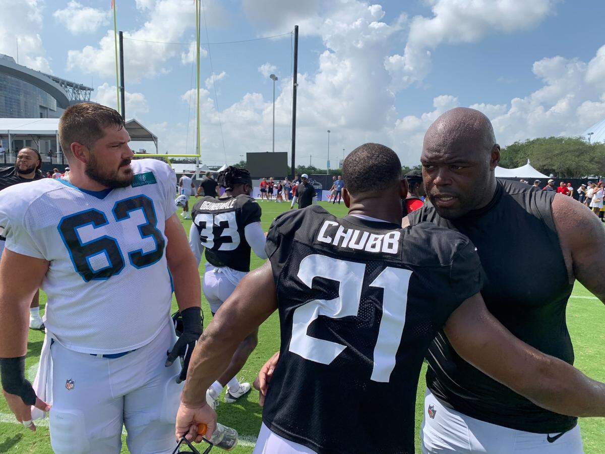 Houston Texans RB Nick Chubb greets Carolina Panthers center Austin Corbett and defensive end A’Shawn Robinson following joint practice in Houston on Aug. 14, 2025.