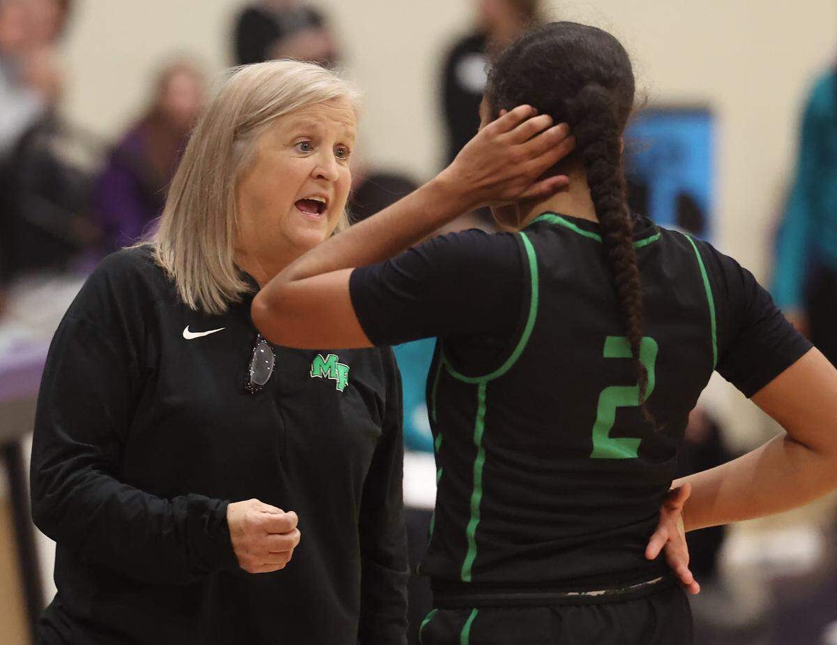Myers Park girls’ basketball coach Barbara Nelson, left, speaks to Camille Christian, right, during a Jan. 28, 2025 game. The Mustangs defeated Palisades 58-44 to give Nelson her 800th career win. 