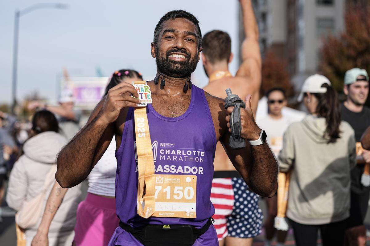A participant smiles after competing in the Novant Health Charlotte Marathon Saturday, Nov. 15, 2025, in Charlotte, N.C.