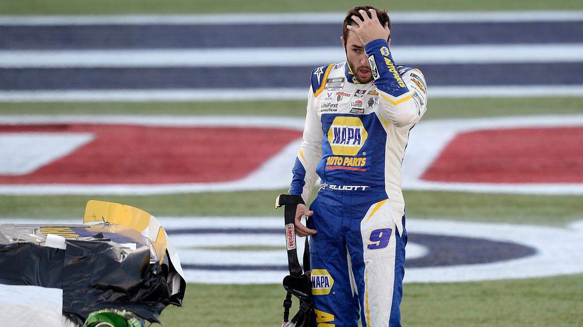 NASCAR driver Chase Elliott rubs his forehead after climbing from his car to see the damage sustained from a wreck with driver Kevin Harvick during the Bank of America Roval 400 at Charlotte Motor Speedway in Concord on Sunday. Elliott advanced to the next round of the playoffs.
