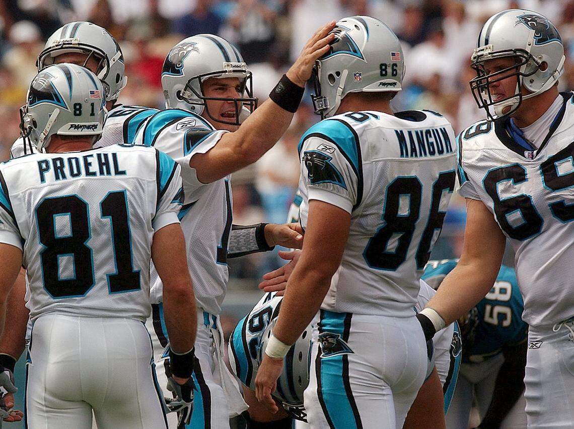 Jake Delhomme pats tight end Kris Mangum (86) on the helmet just after entering his first-ever game as a Carolina Panther, in 2003 against Jacksonville. Delhomme entered the game at halftime and led the Panthers offense to a 24-23 victory.