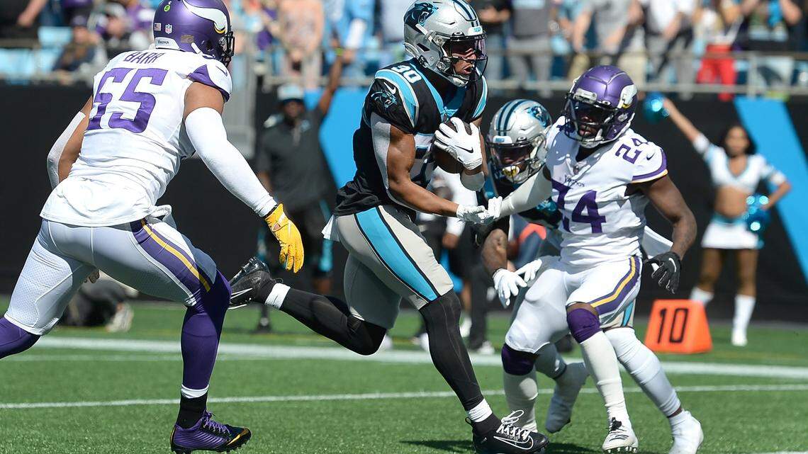Carolina Panthers running back Chuba Hubbard rushes between Minnesota Vikings defenders for a touchdown Sunday at Bank of America Stadium.
