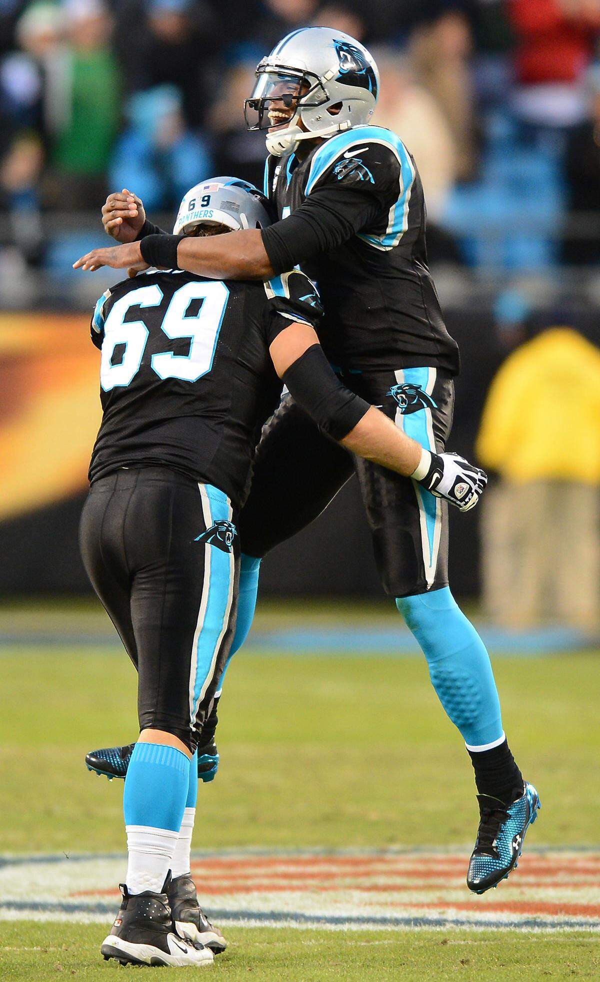 Carolina Panthers tackle Jordan Gross (69) and quarterback Cam Newton celebrate a touchdown in 2013.