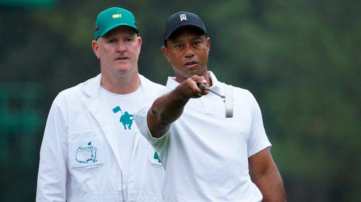 Tiger Woods (right) talks with caddie Joe LaCava during a practice round at Augusta National. LaCava, who now caddies for Patrick Cantlay, was Woods’ caddie for about a decade, including when Woods won the 2019 Masters.