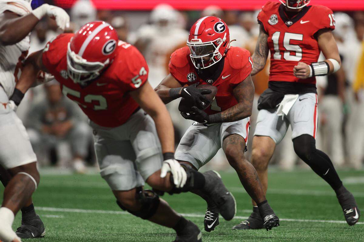 Dec 7, 2024; Atlanta, GA, USA; Georgia Bulldogs running back Trevor Etienne (1) rushes for a touchdown in overtime to defeat the Texas Longhorns in the 2024 SEC Championship game at Mercedes-Benz Stadium. Mandatory Credit: Brett Davis-Imagn Images
