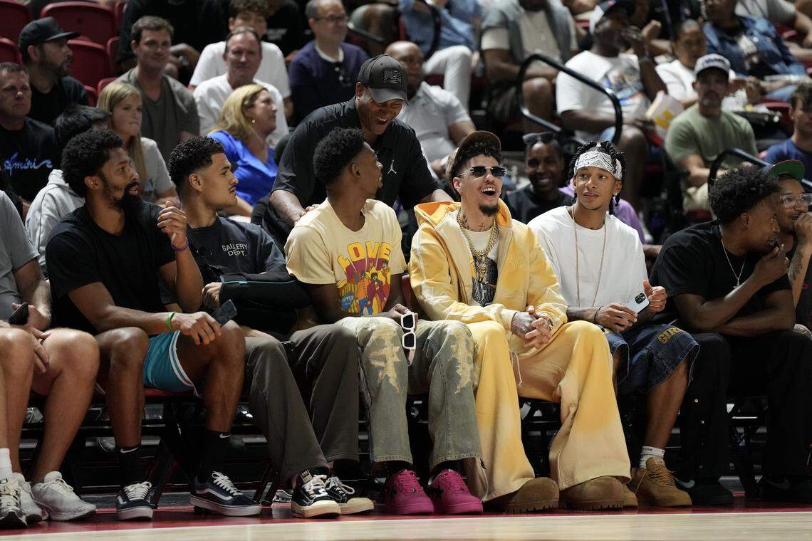Jul 12, 2025; Las Vegas, NV, USA; Charlotte Hornets players Spencer Dinwiddie, Josh Okogie, Josh Green, Brandon Miller, LaMelo Ball and Tre Mann sit courtside for the Charlotte Hornets and Philadelphia 76ers game at Thomas & Mack Center. Mandatory Credit: Candice Ward-Imagn Images