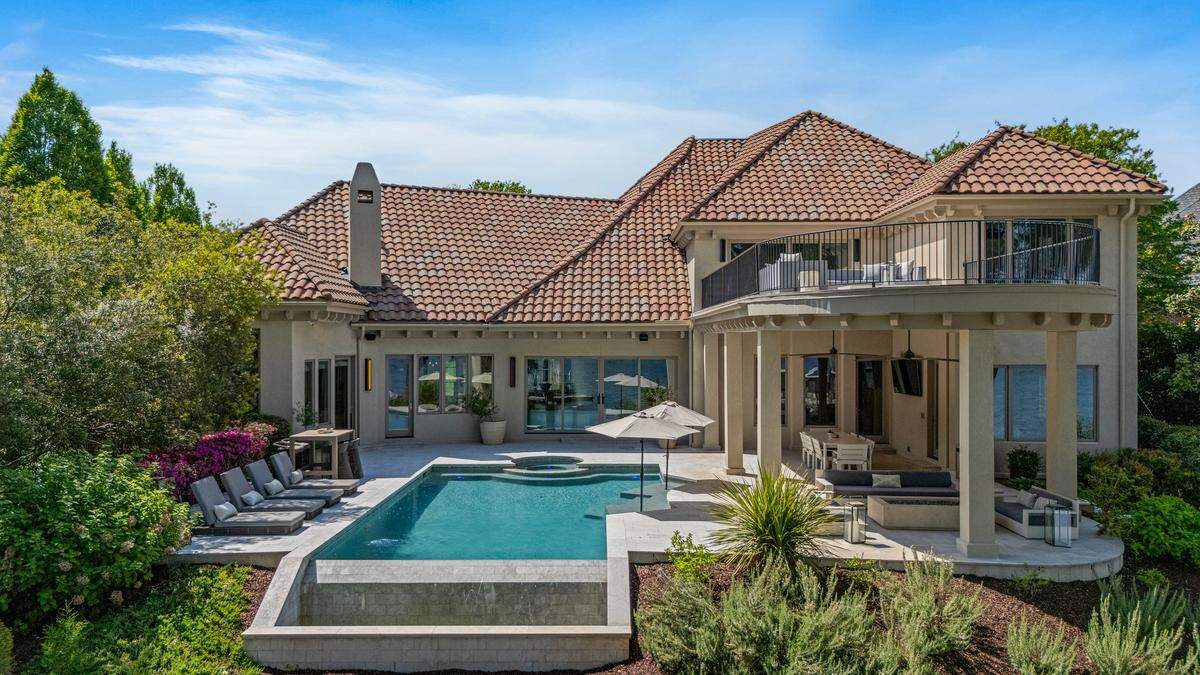 Outdoor features of the mansion include an infinity-edge pool and spa, and a private dock.