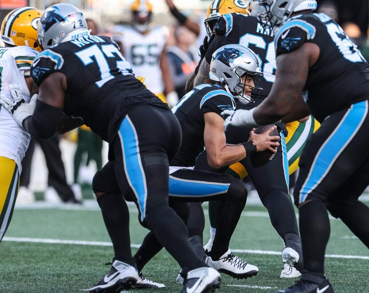 Carolina Panthers’ Bryce Young (9) runs the ball on a quarterback keeper during the game against the Packers at Bank of America Stadium on Sunday, December 24, 2023.