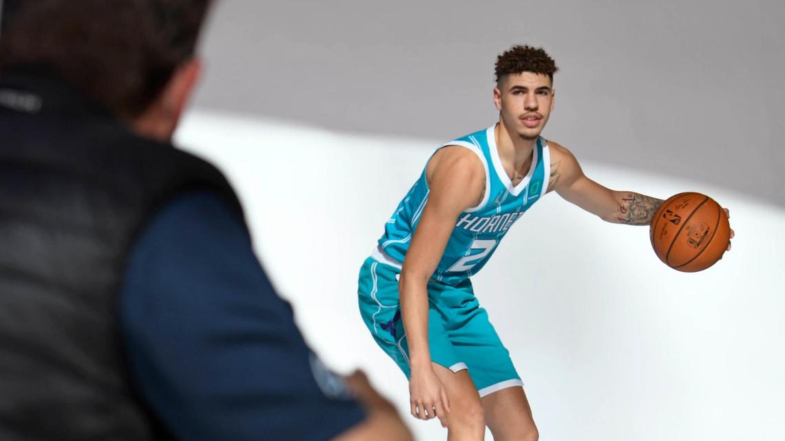 In this 2020 photo, Charlotte Hornets first round draft pick LaMelo Ball dribbles as he gets photographed by photographer Kent Smith after a press conference outside the Spectrum Center.