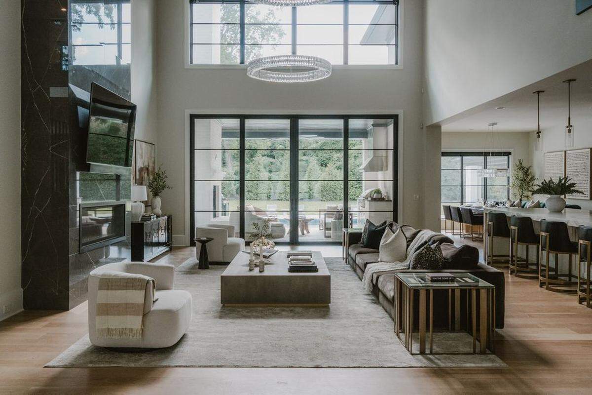 The home includes a two-story great room with dual chandeliers resembling those in a grand European hotel lobby.