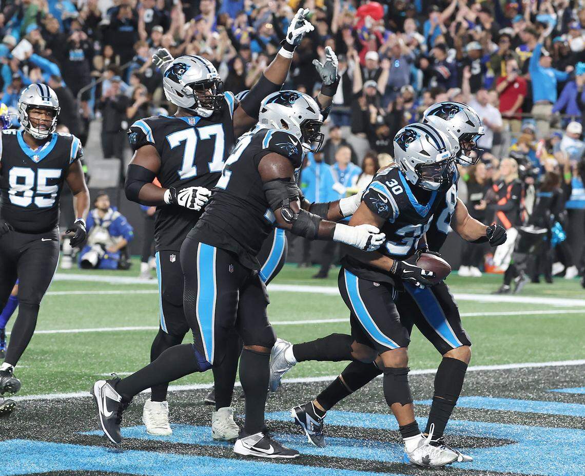 Carolina Panthers running back Chuba Hubbard, right, begins to celebrate a touchdown run against the Los Angeles Rams at Bank of America Stadium on Saturday, January 10, 2026. The Rams defeated the Panthers 34-31.