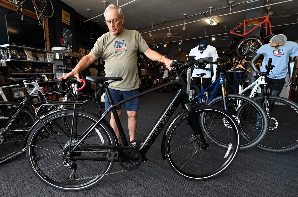 Bicycle Sport employee Bob Carter discusses the customer options available on the Trek hybrid “utility” bicycle in Charlotte, NC on Tuesday, June 30, 2026.