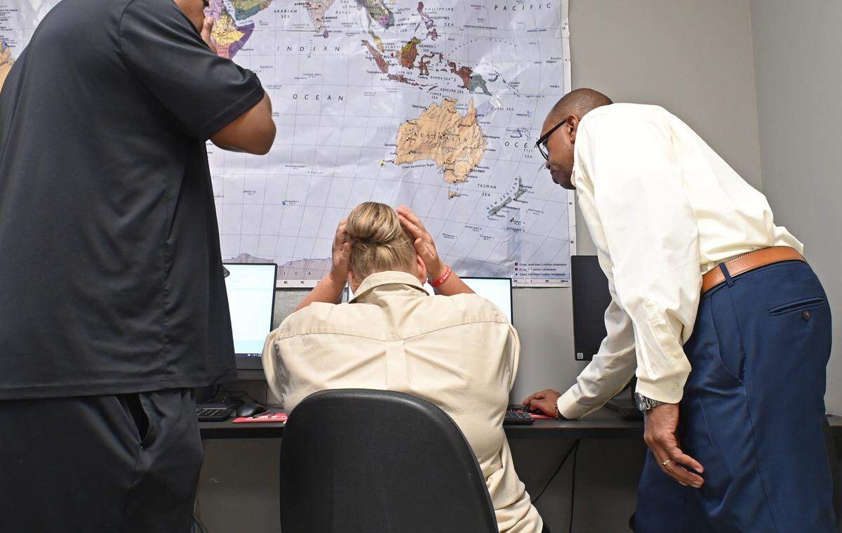 NC Works employee Jesse Williams, Jr., right, helps clients Aug. 30 at the CVCC Applied Technologies Center in Taylorsville, N.C.