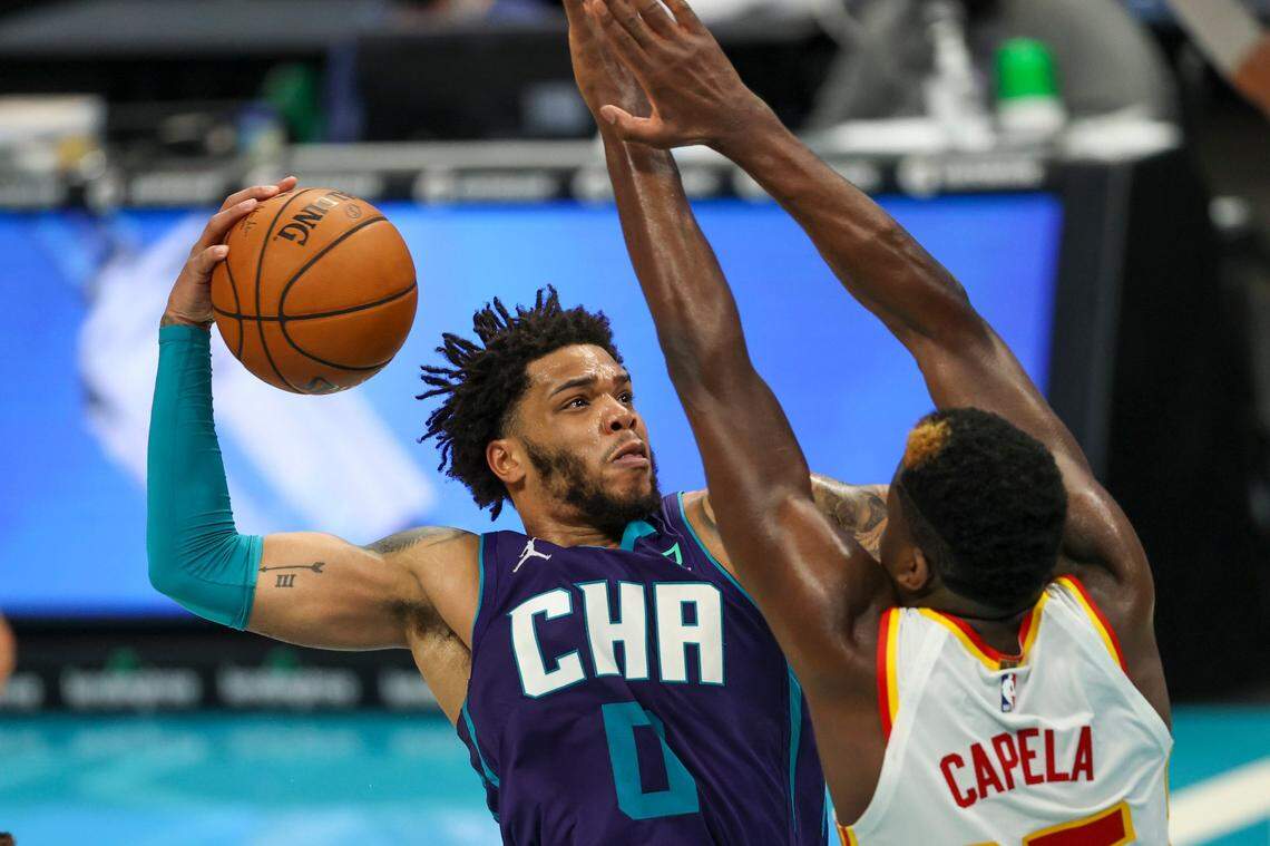 Charlotte Hornets forward Miles Bridges dunks over Atlanta Hawks center Clint Capela (15) on April 11 at Spectrum Center.