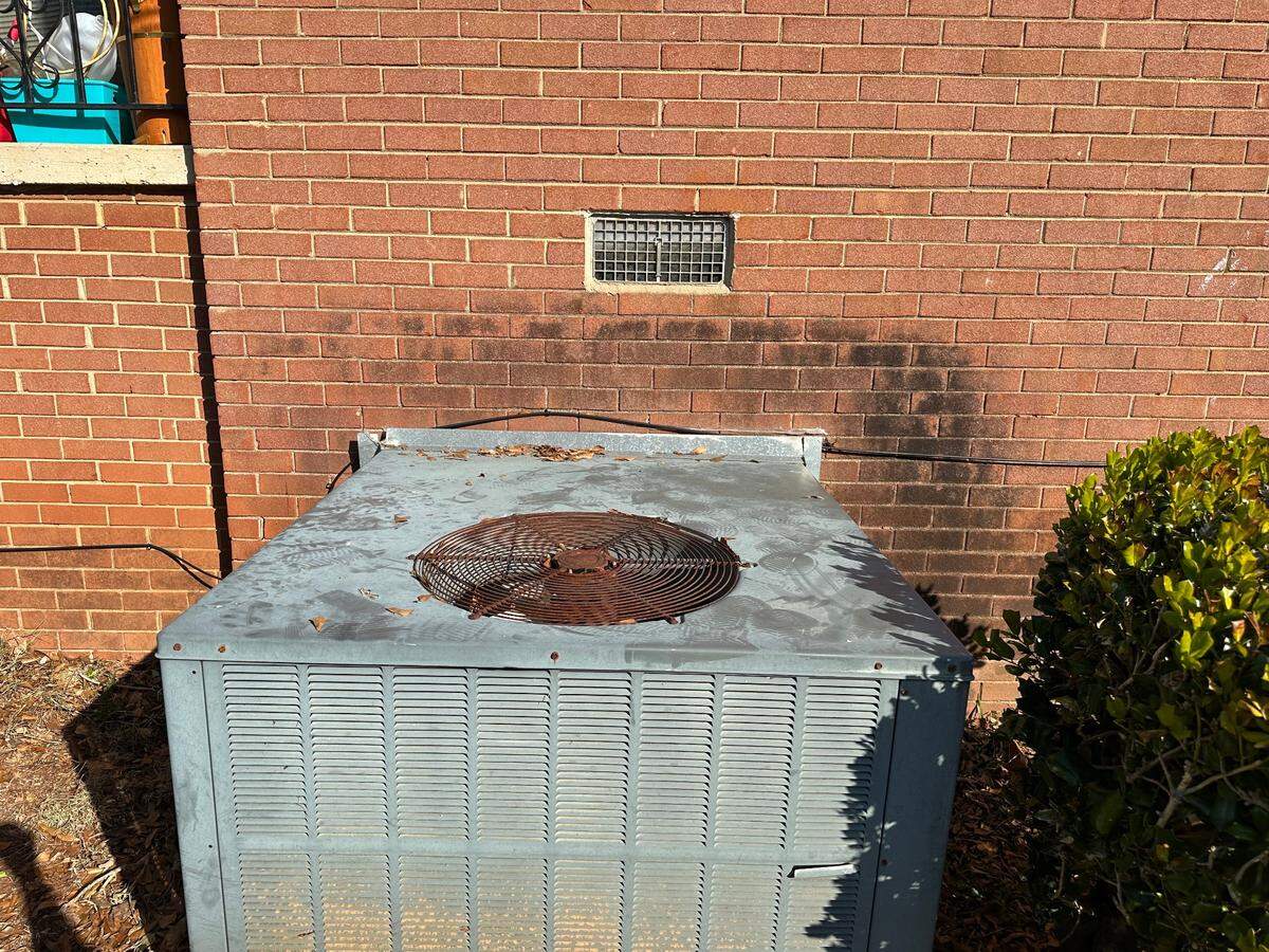 The HVAC system the burglar used to break into the woman’s home through her window, still covered in his footprints.