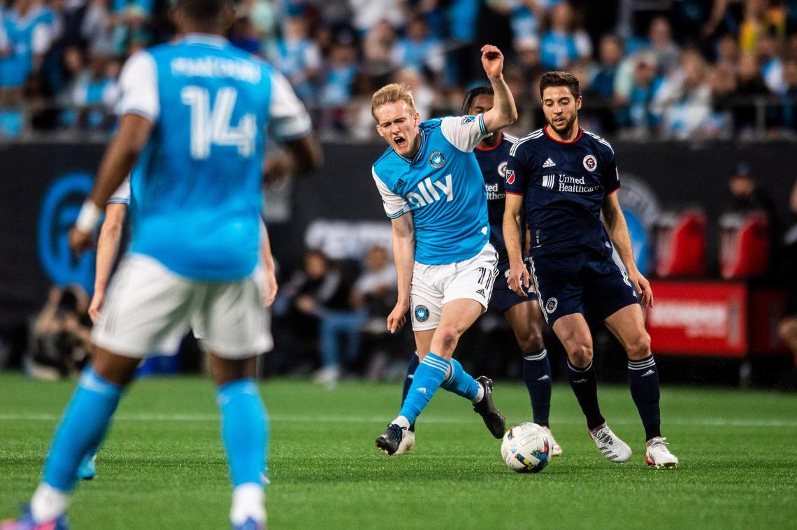 Charlotte FC’s Karol Swiderski, center, cries out as he passes the ball during the game against New England at Bank of America Stadium on Saturday, March 19, 2022 in Charlotte, NC.