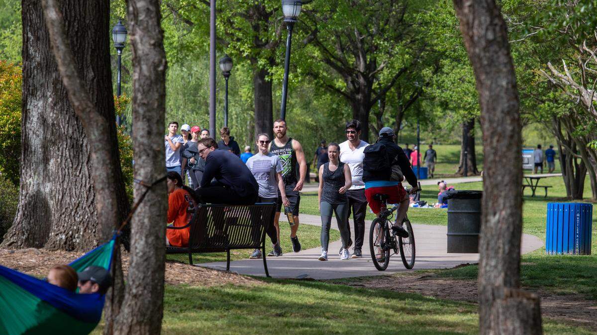 People still crowd public spaces after Mecklenburg County closed off the parking lots to the parks due to the COVID-19 pandemic. Shown here is Freedom Park on April 11, 2020.