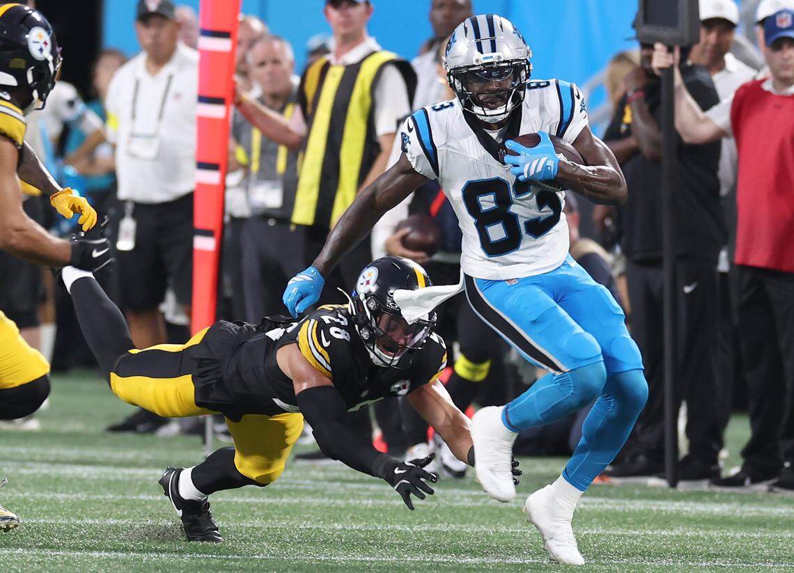 Carolina Panthers wide receiver David Moore, right, fights for yardage against the Pittsburgh Steelers defense at Bank of America Stadium in Charlotte, NC on Thursday, August 21, 2025.