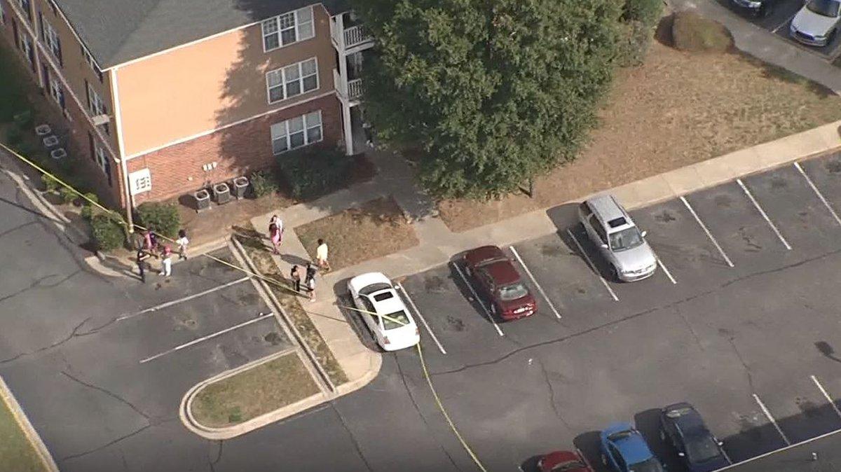 In this image from WBTV’s helicopter, Sky 3, police tape can be seen around an apartment building in the 1700 block of Willow Haven Lane in Charlotte, NC, on Monday, Oct. 25, 2021. Three people have been shot, according to Mecklenburg EMS.