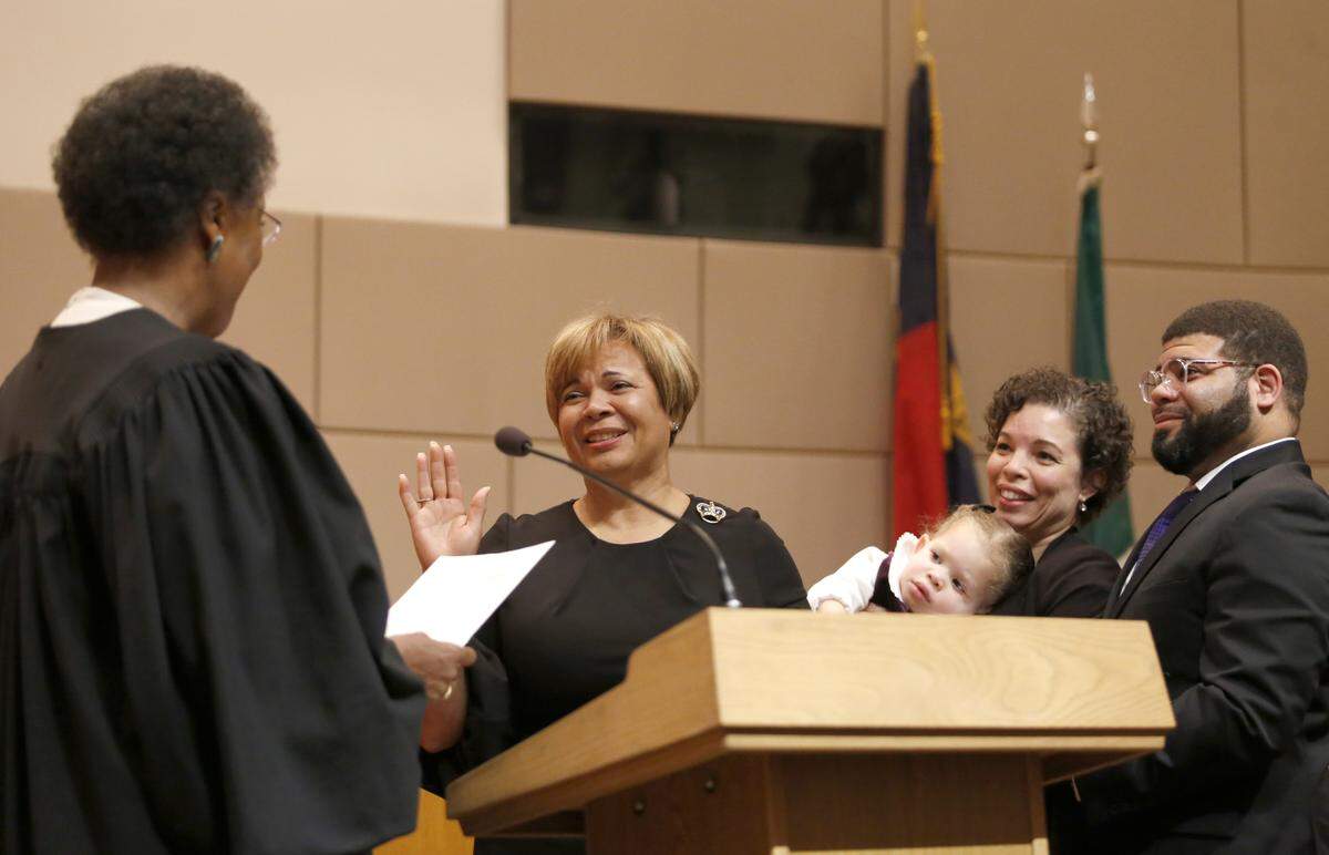 Mayor-elect Vi Lyles is sworn in by Superior Court Judge Yvonne Mims Evans while her family during the 2017 Oath of Office Ceremony in Charlotte on Monday, December 4, 2017.