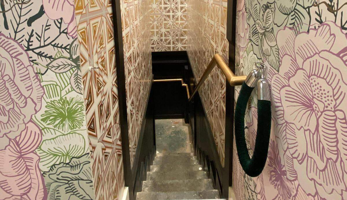Supperland’s speakeasy is tucked underneath restaurant’s floral-wallpapered bar, in a separate building from the main restaurant.