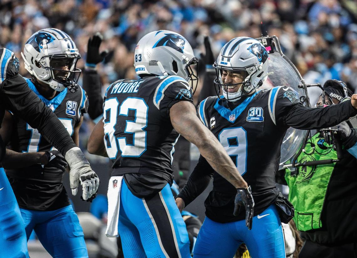 Carolina Panthers quarterback Bryce Young, right, celebrates a touchdown with wide receiver David Moore at the Bank of America Stadium in Charlotte, N.C., on Sunday, December 1, 2024.