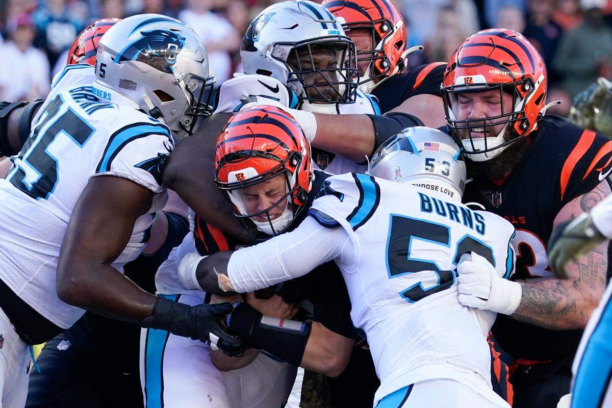 Cincinnati Bengals quarterback Joe Burrow (9) is gang tackled by the Carolina Panthers defense during the first half of an NFL football game, Sunday, Nov. 6, 2022, in Cincinnati. (AP Photo/Joshua A. Bickel)