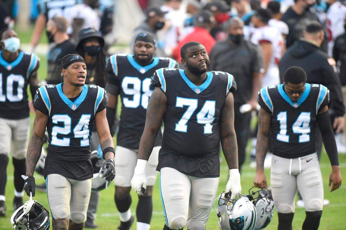 Panthers cornerback Rasul Douglas, left, and offensive tackle Greg Little, right, walk off the field at Bank of America Stadium after losing to the Tampa Bay Buccaneers on Sunday.