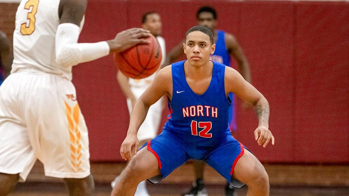 North Meck’s Tristan Maxwell (12) defends during early first quarter action at West Charlotte.