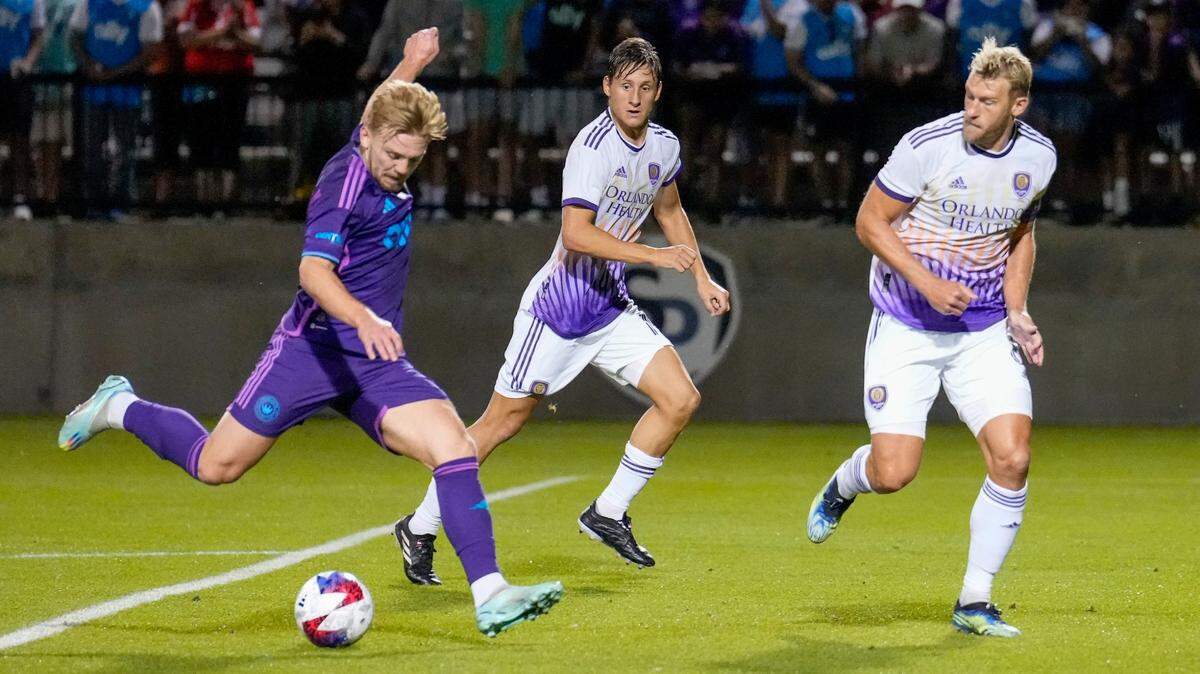Charlotte FC midfielder Kamil Jozwiak (7) tries to pass Orlando City defender Robin Jansson (6) during the second half at Mecklenburg County Sportsplex.