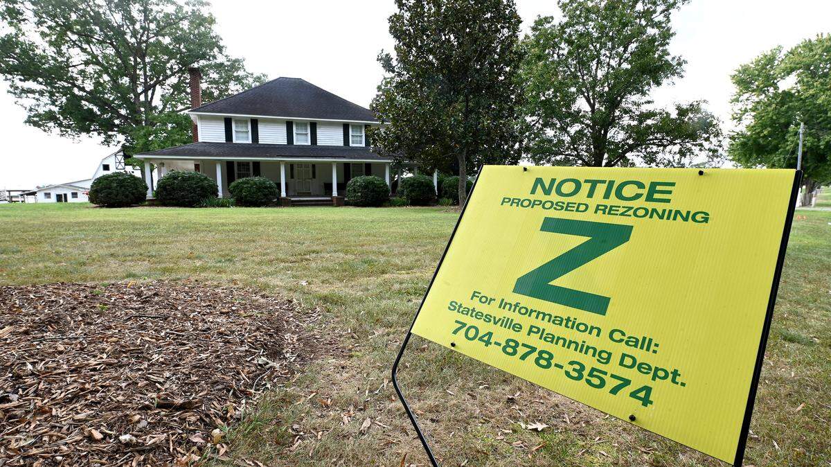 A sign at the Stamey Farms property in western Iredell County on Monday announces that the landowners were seeking a rezoning. Statesville City Council approved the rezoning for a massive data center by a Texas developer.