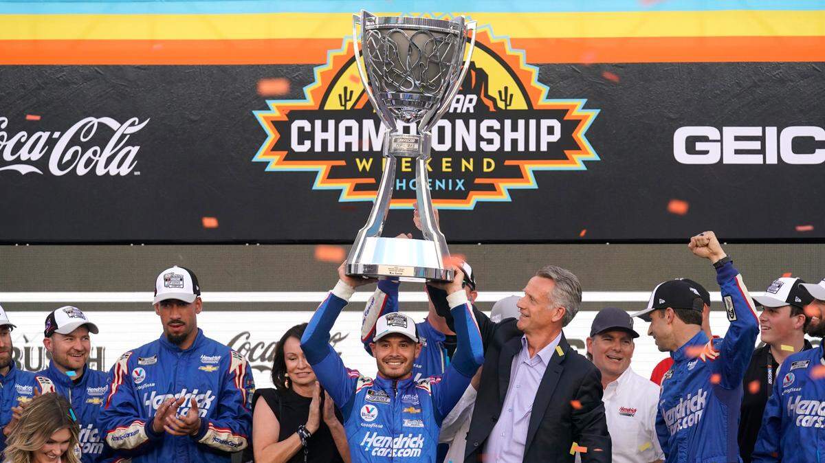 Kyle Larson, center, celebrates after winning a NASCAR Cup Series auto race and championship on Sunday, Nov. 7, 2021, in Avondale, Ariz. (AP Photo/Rick Scuteri)