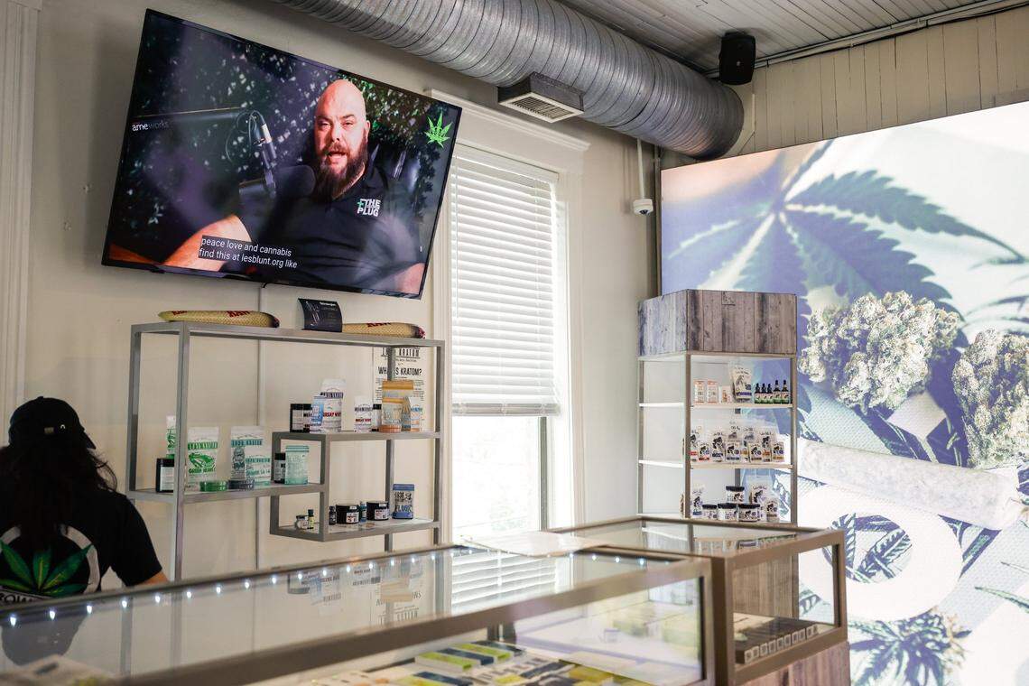 A television monitor inside Crowntown Cannabis shows store owner, Michael Sims, as he hosts his own podcast, Let’s Be Blunt, on Tuesday, April 9, 2024