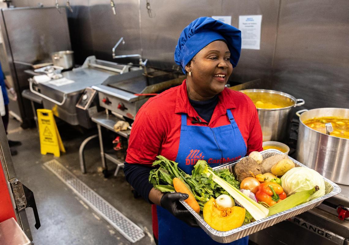 Owner of Ms. Didi’s, Edith Jean-Francois, holds up a tray with the ingredients for soup joumou in Charlotte on Tuesday, Dec. 31, 2024.
