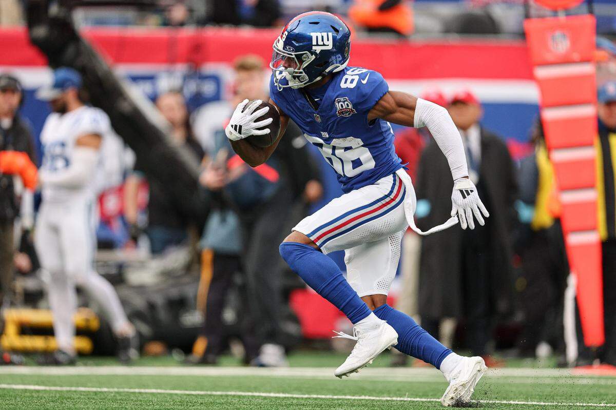 Dec 29, 2024; East Rutherford, New Jersey, USA; New York Giants wide receiver Darius Slayton (86) scores a touchdown reception during the first half against the Indianapolis Colts at MetLife Stadium. Mandatory Credit: Vincent Carchietta-Imagn Images
