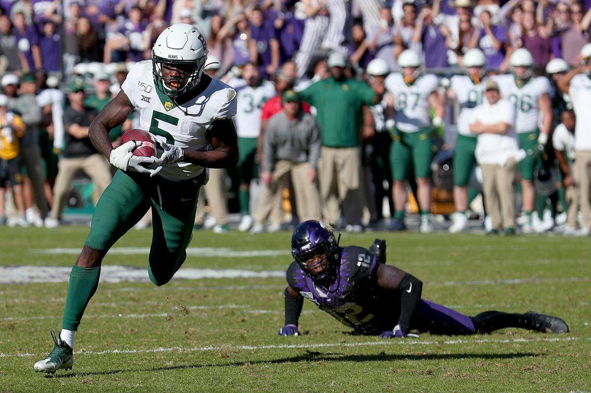 Baylor wide receiver Denzel Mims (5) scores on a 20-yard touchdown catch as a fallen Jeff Gladney of Texas Christian’s can only look on in the second overtime at Amon G. Carter Stadium in Fort Worth, Texas, on Saturday, Nov. 9, 2019. Baylor won, 29-23, in 3OT. (Tom Pennington/Getty Images/TNS)