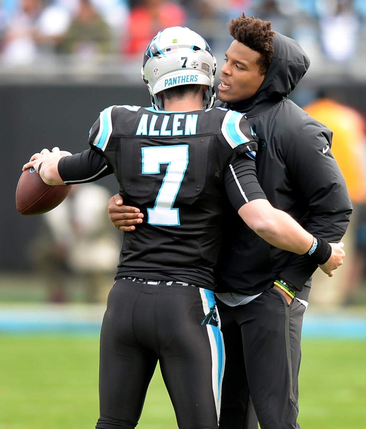 Kyle Allen (left) got a hug from Cam Newton when he made his NFL debut against the Atlanta Falcons in December 2018.