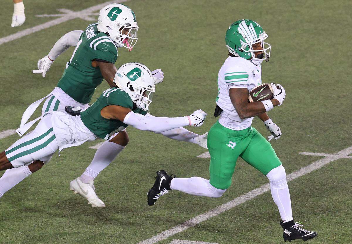 North Texas running back Kiefer Sibley, right, breaks free of the Charlotte 49ers defense for a touchdown during action on Friday, October 24, 2025 at Jerry Richardson Stadium. North Texas defeated Charlotte 54-20.